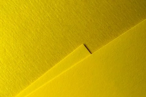 Bright yellow paper creating textures and patterns in soft light Foto stock