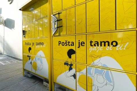 A bright yellow parcel locker machine in Podgorica, Montenegro Stock Photos
