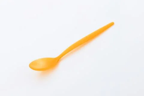 Bright yellow plastic spoon isolated Stock Photos