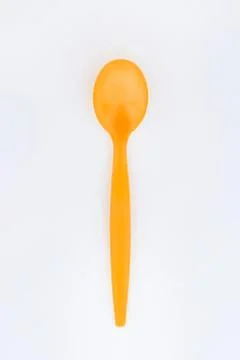 Bright yellow plastic spoon isolated Stock Photos