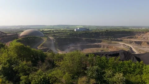 A Bright Yellow Rapeseed Field Borders the Irish Cement Plant in Drogheda Stock Footage 314552059