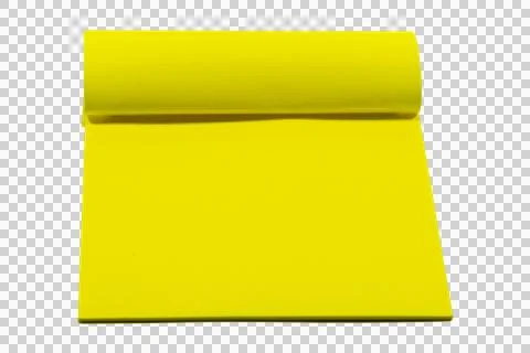 Bright yellow rectangular paper pad with a curled edge, isolated on a plain. Stock Photos