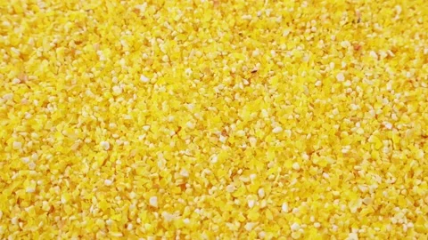Bright yellow small corn grits texture circle rotation close up Stock Footage 233106828
