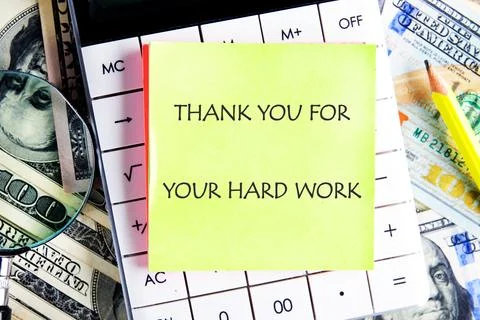 A bright yellow sticky note with a message of thanks is positioned on a calcu Stock Photos