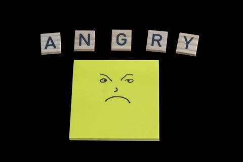 Bright yellow sticky note shows a frowning face Stock Photos