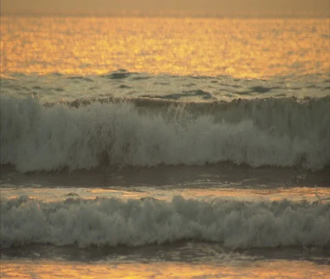 Bright yellow sun behind dark orange clouds over ocean Stock Footage 86747507