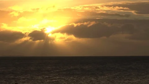 Bright yellow sun in sky over ocean Stock Footage 74062591