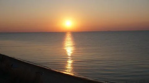 Bright yellow sunrise on seaside of the Black sea Stock Photos