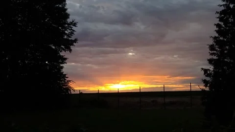 A bright yellow sunset on the horizon Stock Footage 312230747