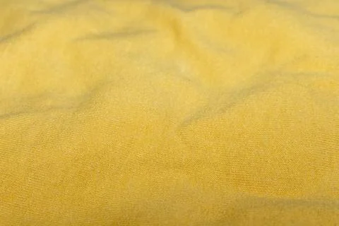 A bright yellow textile background with soft folds and a natural texture 스톡 사진