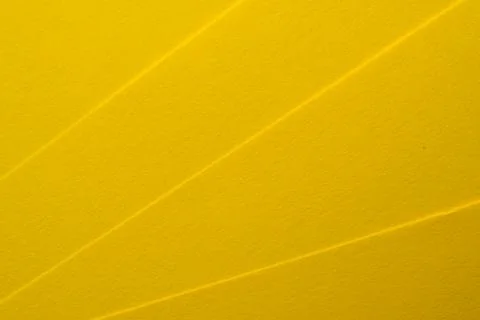 Bright yellow texture with vivid lines creating artistic patterns Stock Photos