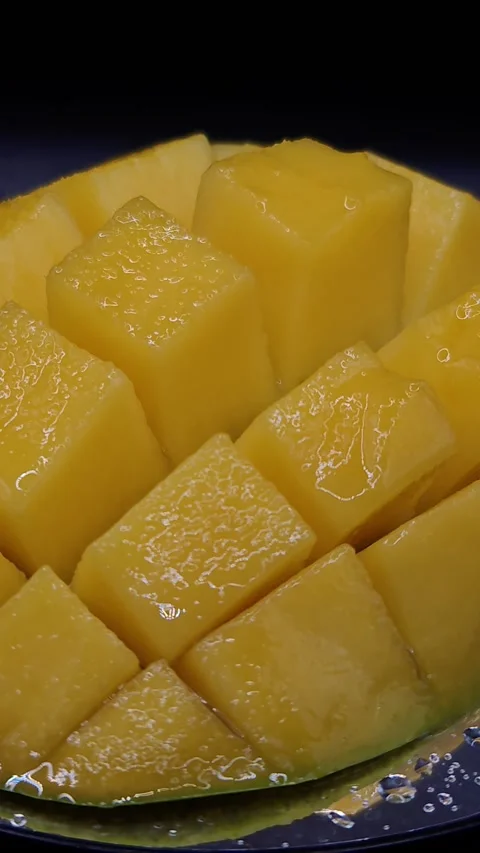 Bright yellow wet mango macro shot Video stock 329645838