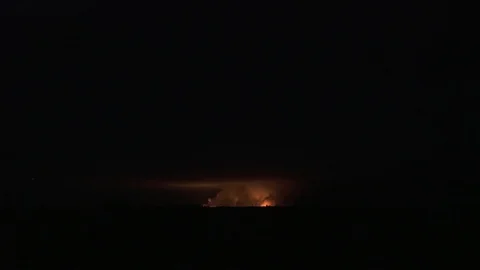 Brightest light caused by the explosion comes out of the smoke, aerial shot Vidéo 97384567