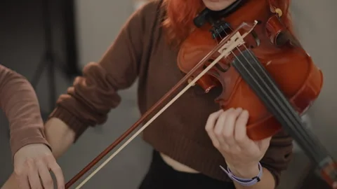 Brighthaired violin player immersed in intense practice session. Redhaired Stock Footage 346555507