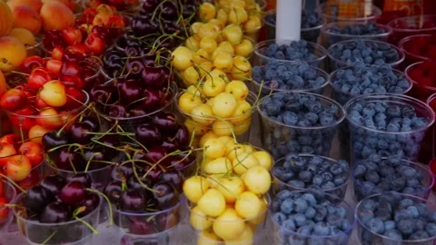 Brightly colored berries in cups showcase ripe summer harvest Video stock 331940344