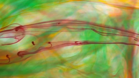 Brightly colored clouds of smoke dance and twist. yellow, blue, green red mix Stock Footage 247782008