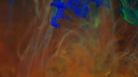 Brightly colored clouds of smoke dance. Hues of yellow, blue, green and red dark Video stock 247782348