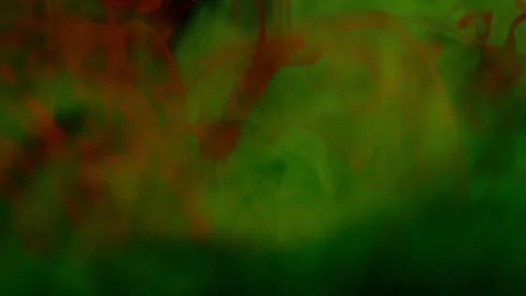 Brightly colored clouds of smoke dance and twist. yellow, blue, green red mix Video stock 247782903