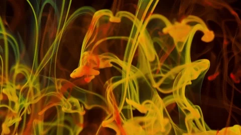 Brightly colored clouds of smoke dance. Hues of yellow, blue, green and red dark Video stock 247783079