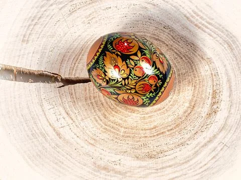 Brightly colored Easter egg with patterns on a wooden background 库存照片