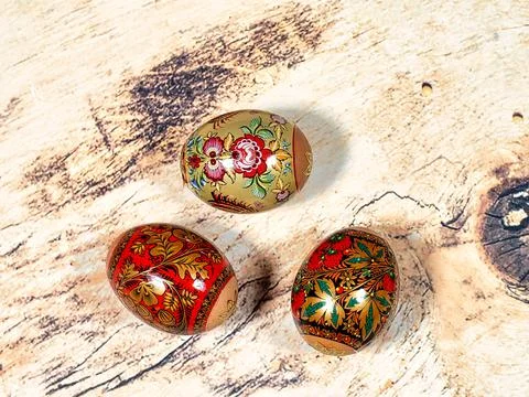 Brightly colored Easter eggs with patterns on a wooden background 库存照片
