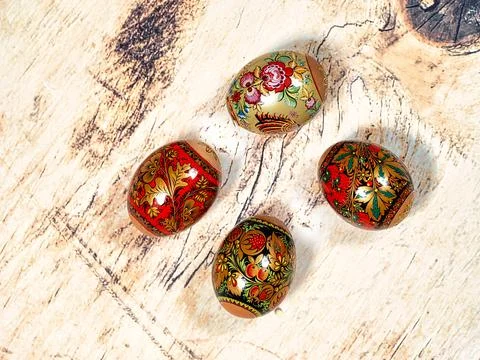 Brightly colored Easter eggs with patterns on a wooden background 库存照片