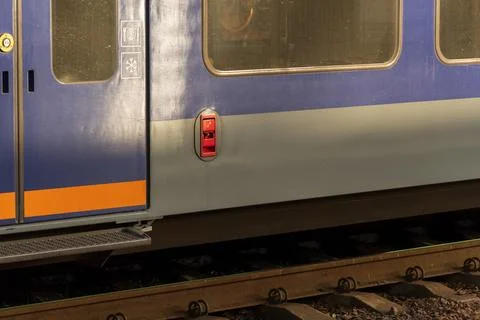 Brightly colored electric train stands at the platform, showcasing industri.. 库存照片