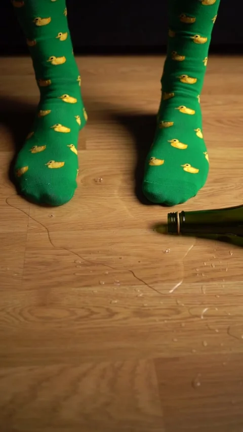 Brightly Colored Green Socks Featuring Adorable Duck Patterns Positioned on a Stock Footage 303576487