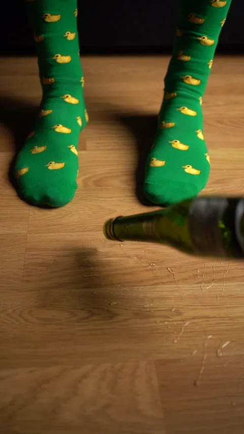 Brightly Colored Green Socks Featuring Adorable Duck Patterns Positioned on a Stock Footage 303576495