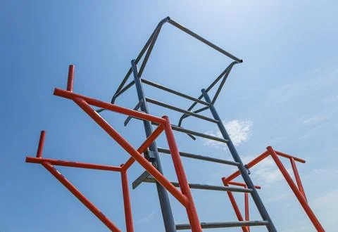 Brightly colored gym structure stands tall against a blue sky, supporting d.. Fotos Stock