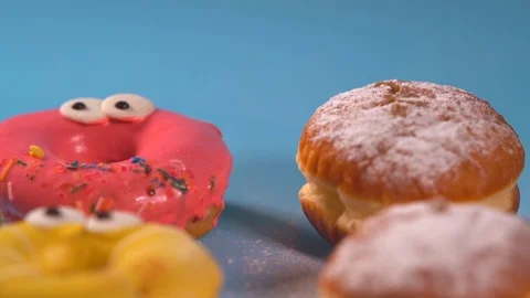Brightly colored iced donuts and fresh cream buns Stock Footage 96312895