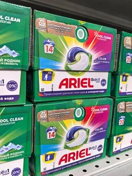Brightly colored laundry detergent packaging displayed on supermarket shelf Stock Photos
