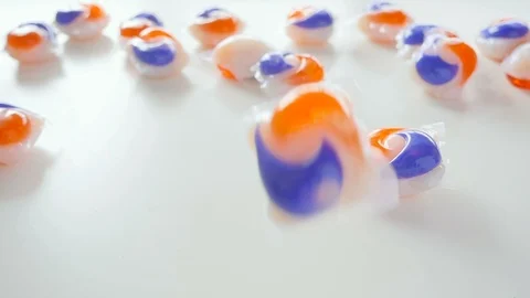 Brightly Colored Laundry Detergent Tide Pods Falling in Slow Motion Stock Footage 85989500