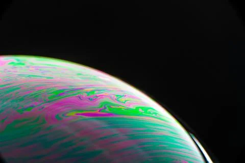 Brightly Colored Macro Bubble on Black Background Photos