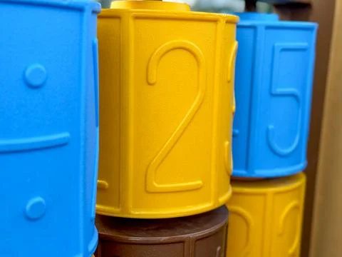 Brightly colored numbers on a play structure at a community park during sunny Stock Photos