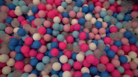 Brightly colored plastic balls in a ball pit at a children's playground. Stock Footage 296876626