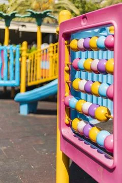 Brightly colored playground features a climbing structure and an abacus, prov Stock Photos