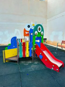 Brightly colored playground structure features slides and climbing elements,  스톡 사진