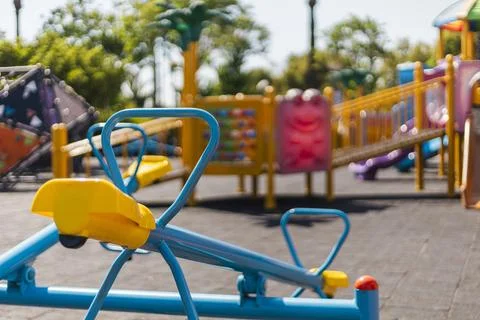 Brightly colored playground structures are set in a sunny park, designed for  Foto stock