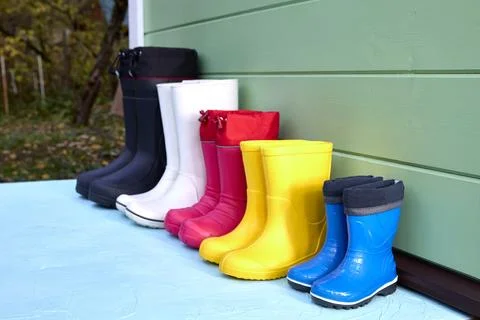 Brightly Colored Rubber Boots Lined Up Outdoors Stock Photos