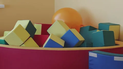 Brightly colored soft foam blocks filling a ball pit in a children's playroom Stock Footage 345971421