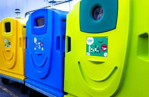 Brightly colored sorted waste bins for recycling at an outdoor fairground Stock Photos