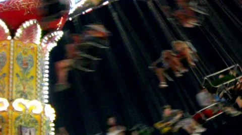 Brightly Colored State Fair Amusement Park Swings Ride Video Against a Black Sky Video stock 8651678