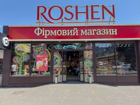 Brightly colored storefront of a sweets shop Roshen in the village of Kotovskogo Stock Photos