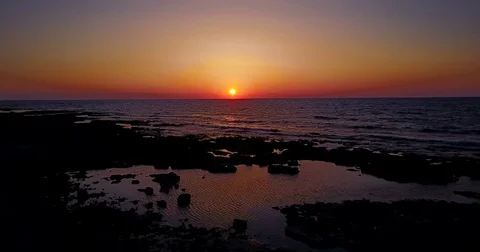 Brightly colored sunset over the calm Mediterranean Sea. Drone Point of View . Stock Footage 74184424