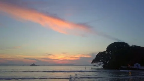 Brightly colored sunset over the calm water drone footage Stock-Footage 84880097