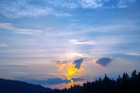 Brightly colorful clouds in the evening sky. Lush colored clouds in the sky.. Stock Photos