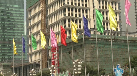 Brightly coloured flags, pan up construction to towering crane Stock Footage 38171781