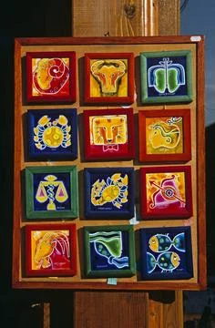  Brightly coloured framed ceramic tile display outside gift and craft shop... Stock Photos