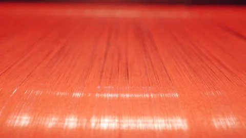 Brightly-coloured threads on a metal roller during weaving 库存影片 156912212